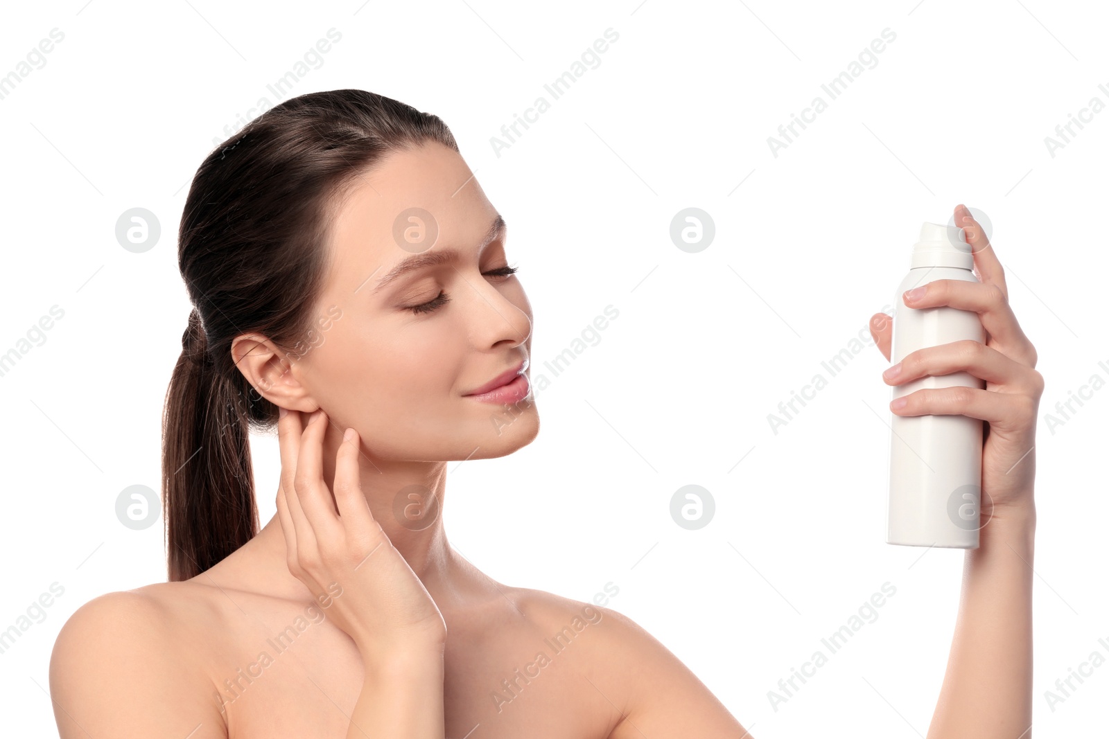 Photo of Young woman applying thermal water on face against white background. Cosmetic product