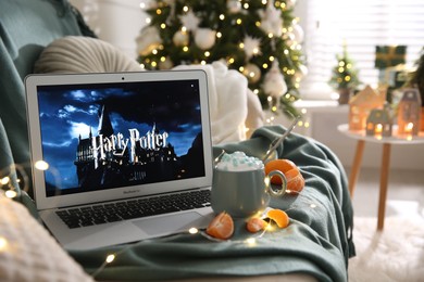 Photo of MYKOLAIV, UKRAINE - DECEMBER 25, 2020: Laptop displaying Harry potter movie indoors. Cozy winter holidays atmosphere