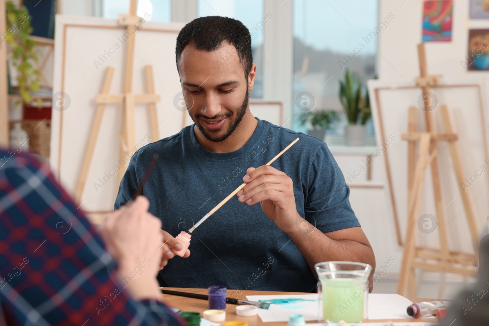 Photo of Students attending painting class in studio. Creative hobby