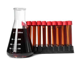 Different laboratory glassware with brown liquids on white background