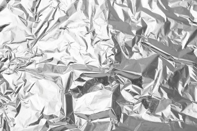 Photo of Crumpled silver foil as background, top view