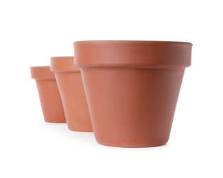 Photo of Stylish terracotta flower pots isolated on white