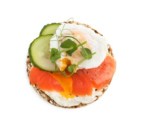 Photo of Crunchy buckwheat cake with salmon, poached egg and cucumber slices isolated on white