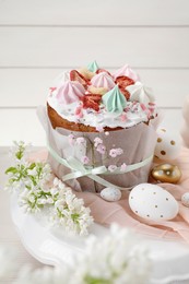 Photo of Traditional Easter cake with meringues and painted eggs on stand