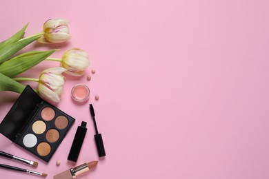 Photo of Flat lay composition with different makeup products and beautiful tulips on pink background. Space for text