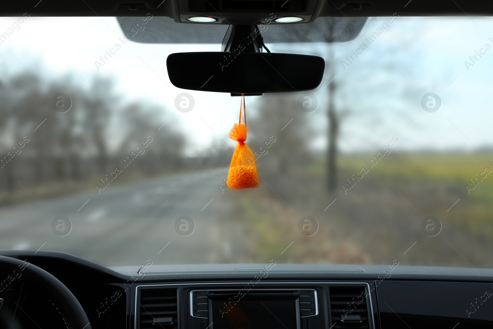 Photo of Air freshener hanging on rear view mirror in car