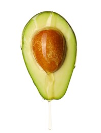 Photo of Pouring cooking oil onto fresh cut avocado on white background
