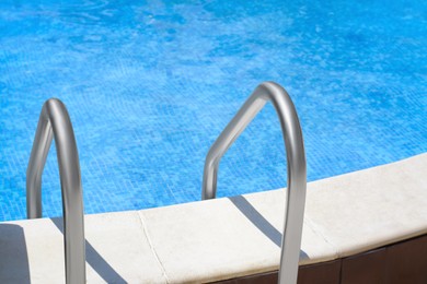 Photo of Swimming pool with metal ladder on sunny day