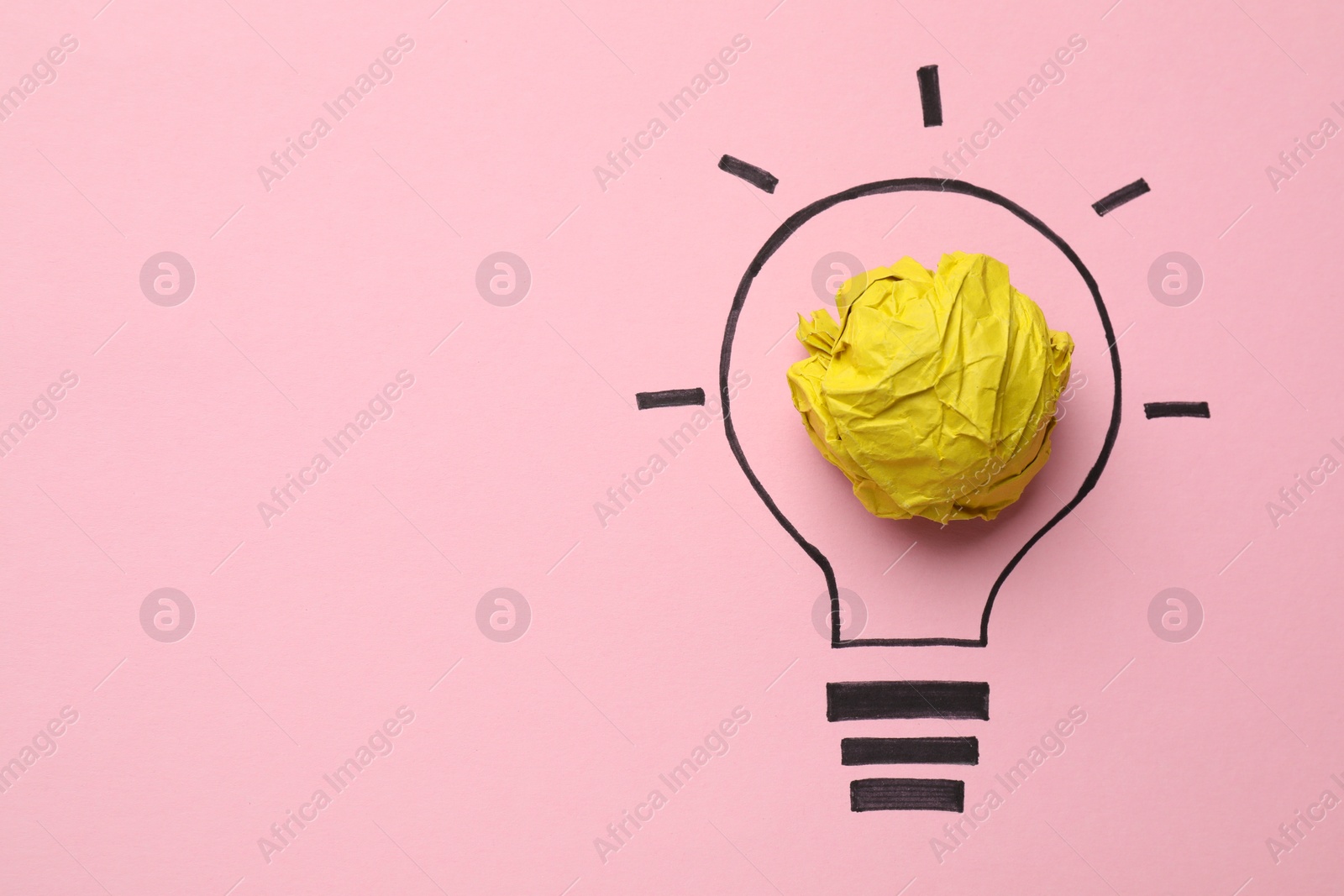 Photo of Idea concept. Light bulb made with crumpled paper and drawing on pink background, top view. Space for text