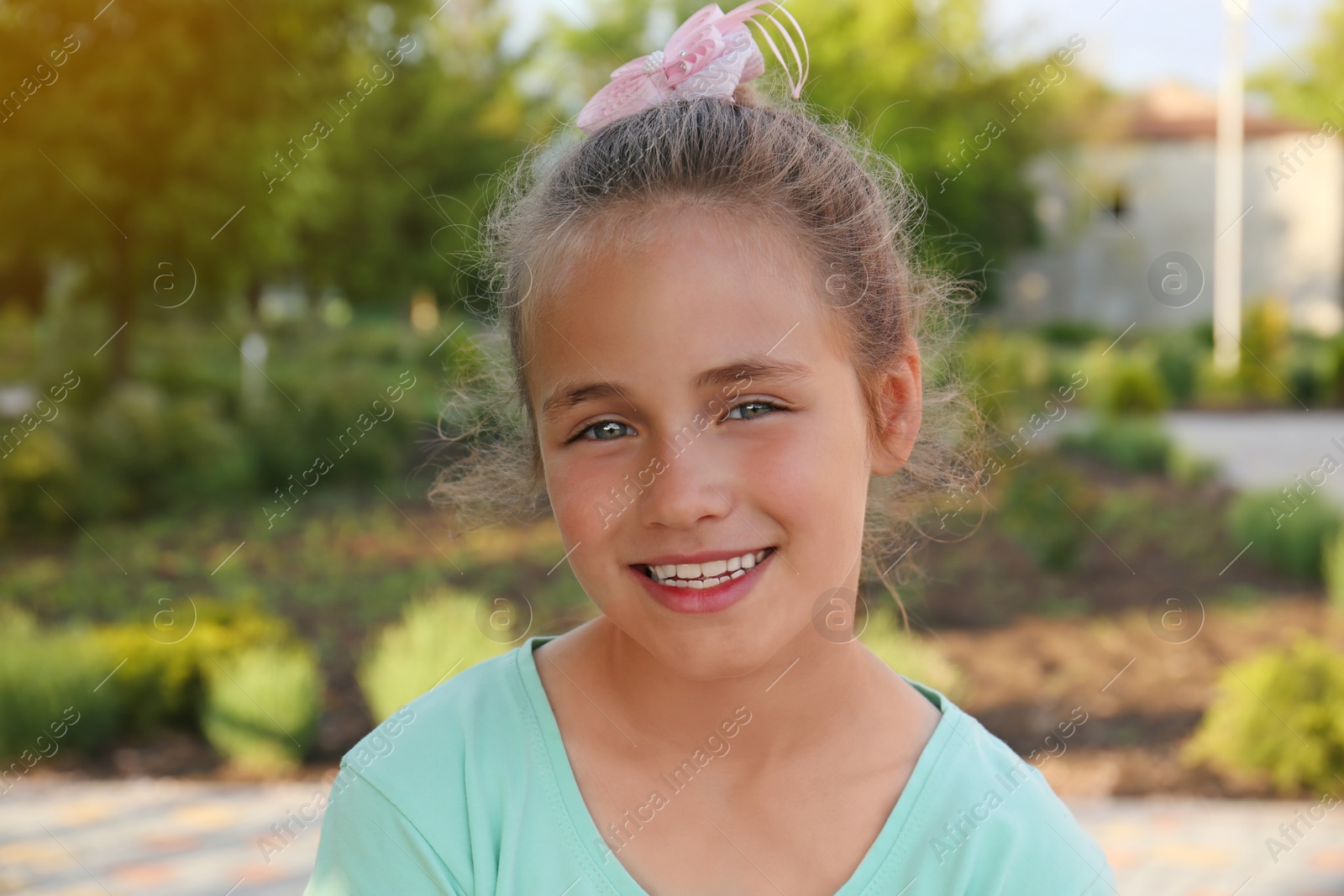 Photo of Portrait of cute happy little girl outdoors