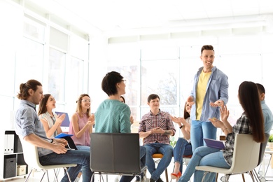 Photo of Male business trainer giving lecture in office