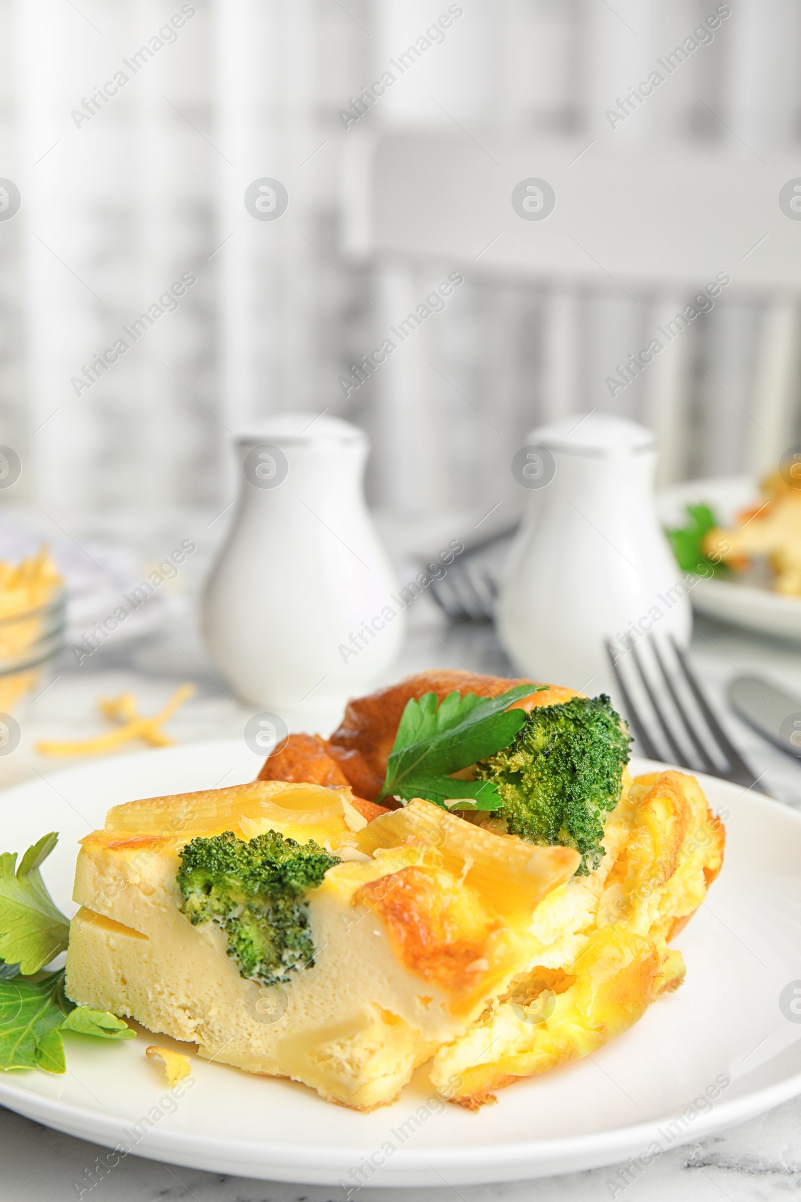 Photo of Tasty broccoli casserole served on white marble table indoors. Space for text