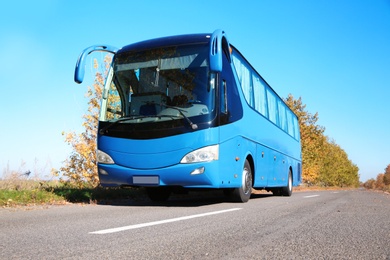 Photo of Modern blue bus on road. Passenger transportation