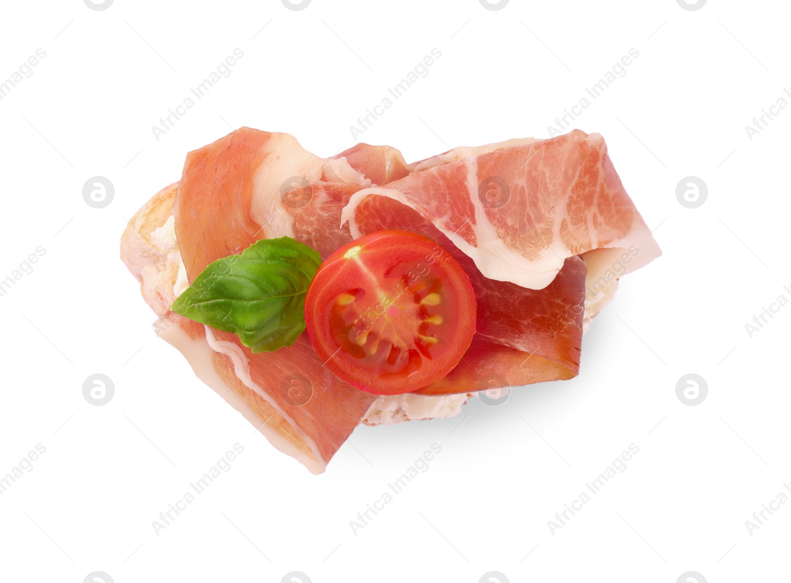 Photo of Tasty sandwich with cured ham, tomato and basil leaf isolated on white, top view