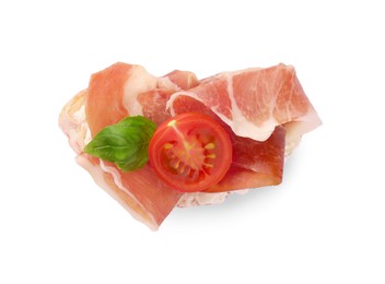 Tasty sandwich with cured ham, tomato and basil leaf isolated on white, top view