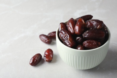 Photo of Bowl with sweet dates on table, space for text. Dried fruit as healthy snack