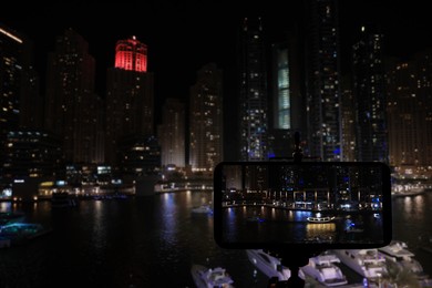 DUBAI, UNITED ARAB EMIRATES - NOVEMBER 03, 2018: Night cityscape of marina district. Taking photo with camera mounted on tripod