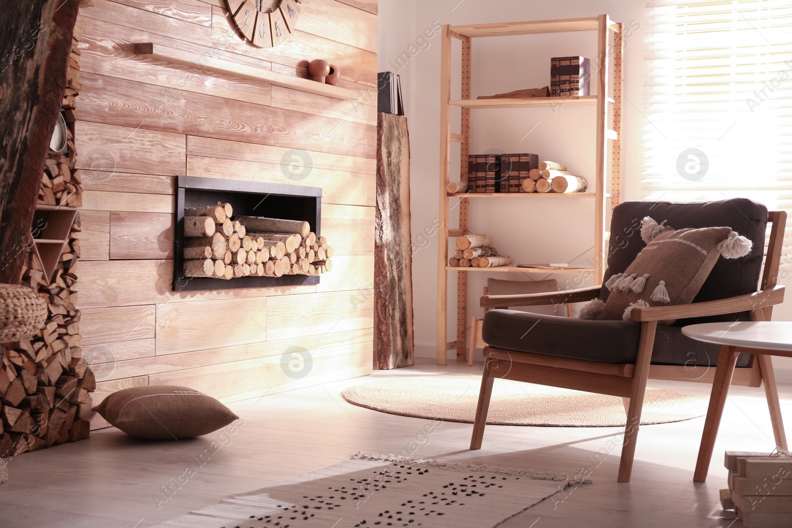 Photo of Decorative fireplace with stacked wood in cozy living room interior