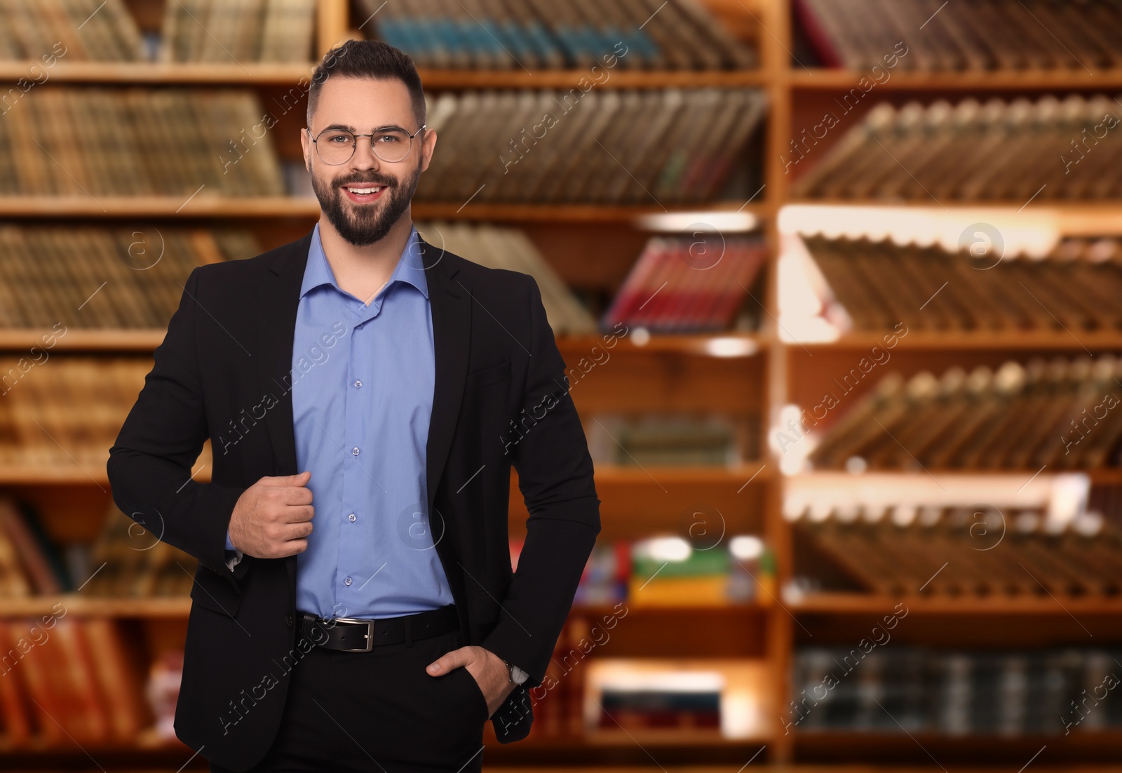 Image of Successful lawyer in glasses against shelves with books, space for text