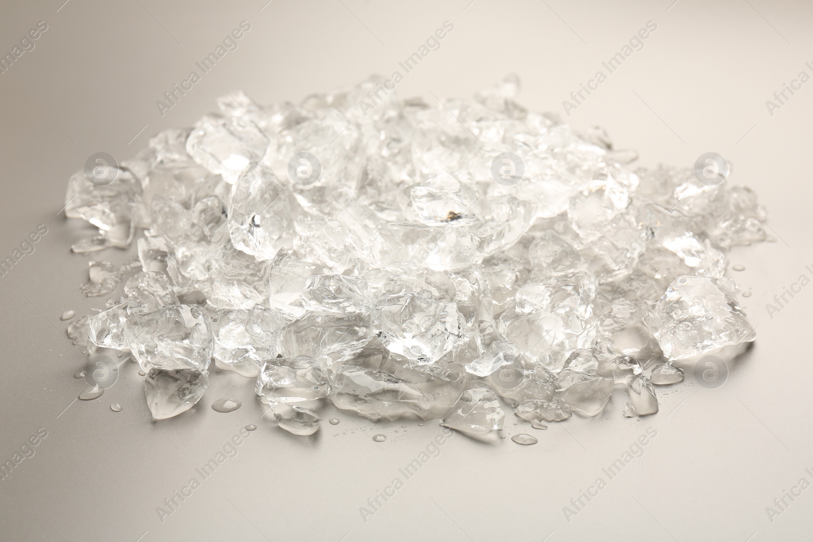 Photo of Pieces of crushed ice on grey background