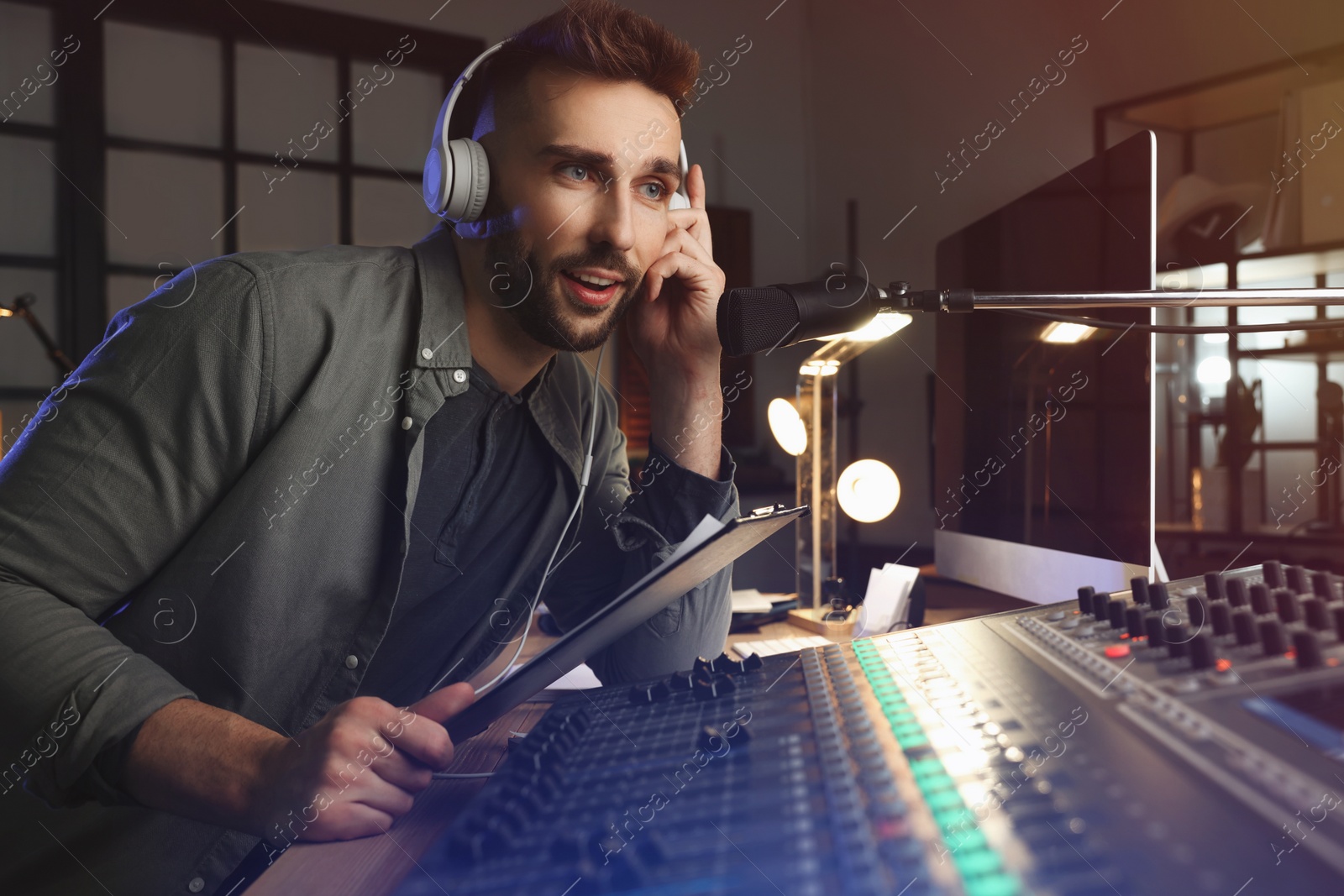 Photo of Man working as radio host in modern studio