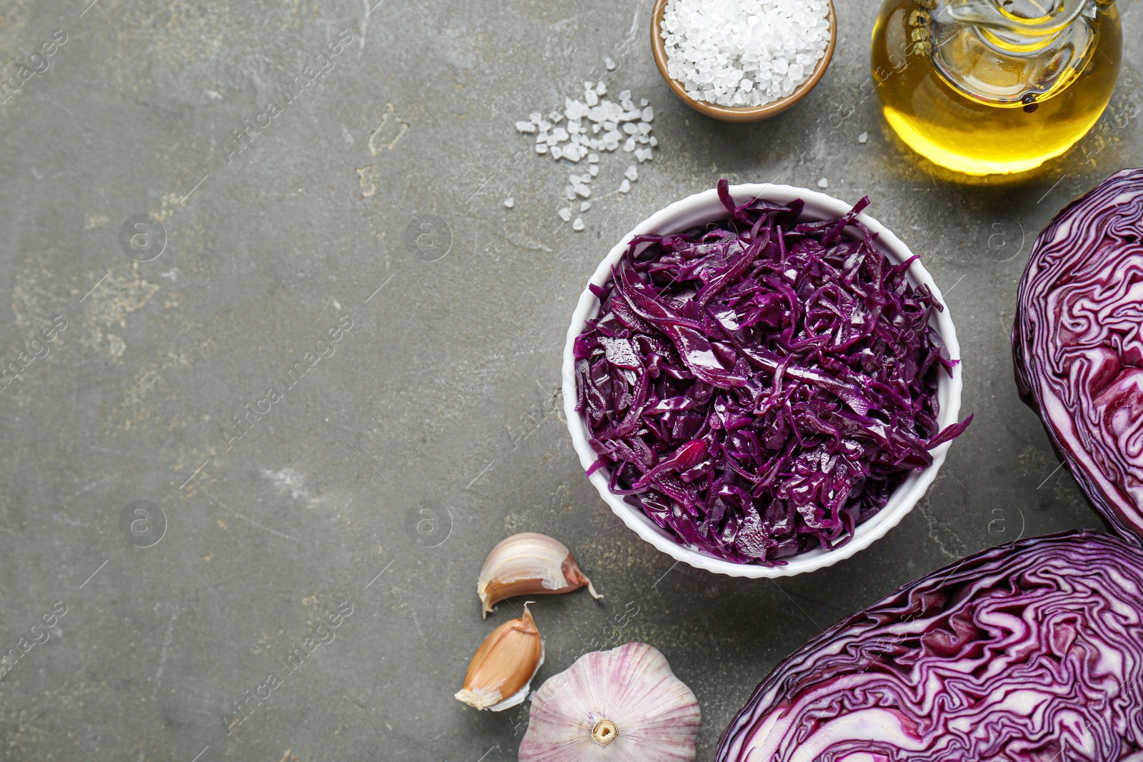 Photo of Tasty red cabbage sauerkraut and different ingredients on light grey table, flat lay. Space for text