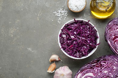 Photo of Tasty red cabbage sauerkraut and different ingredients on light grey table, flat lay. Space for text