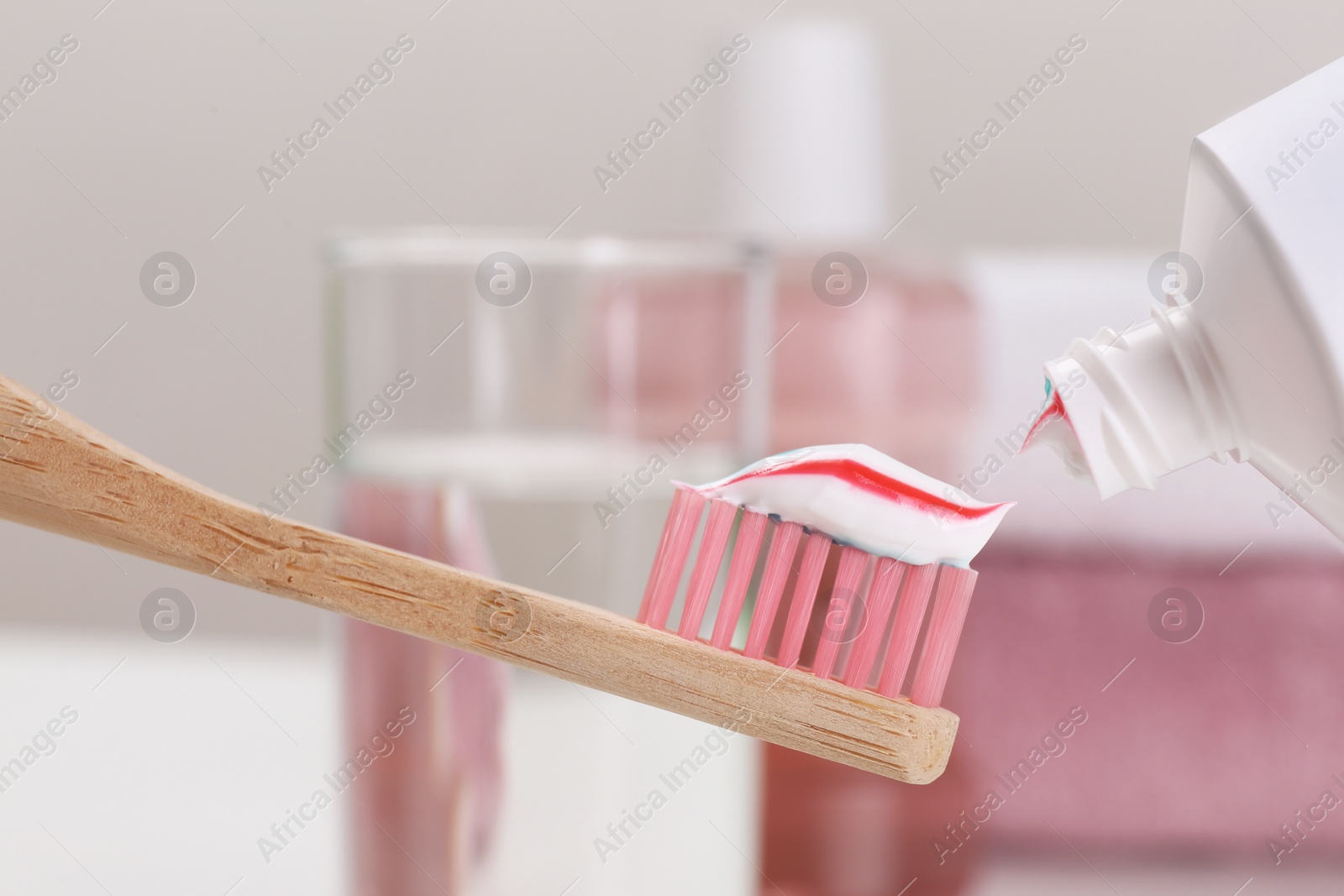 Photo of Applying paste on toothbrush near mouthwash, closeup