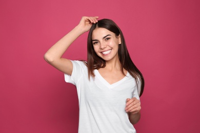 Photo of Portrait of young woman laughing on color background