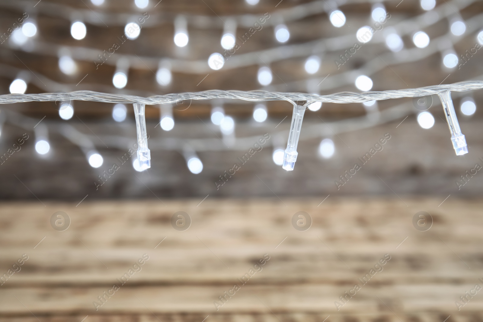 Photo of Beautiful Christmas lights on blurred background, closeup