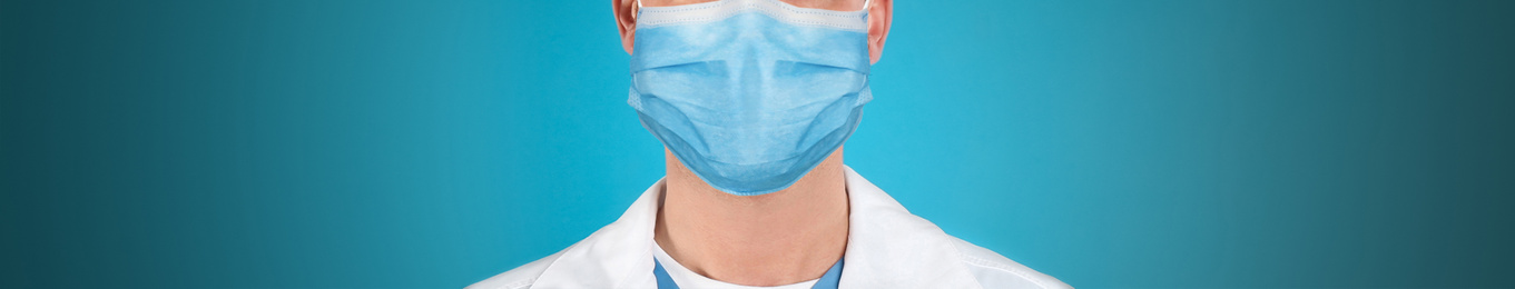 Image of Medical worker wearing face mask on blue background, closeup. Coronavirus safety