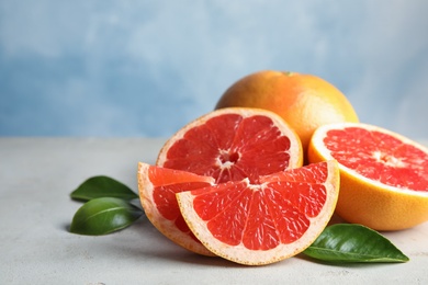 Fresh tasty grapefruits on table. Space for text