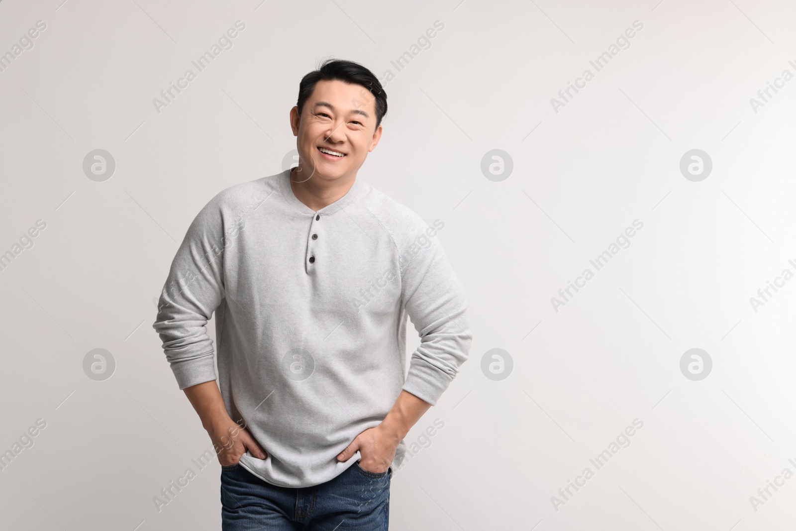 Photo of Portrait of happy man on light background. Space for text