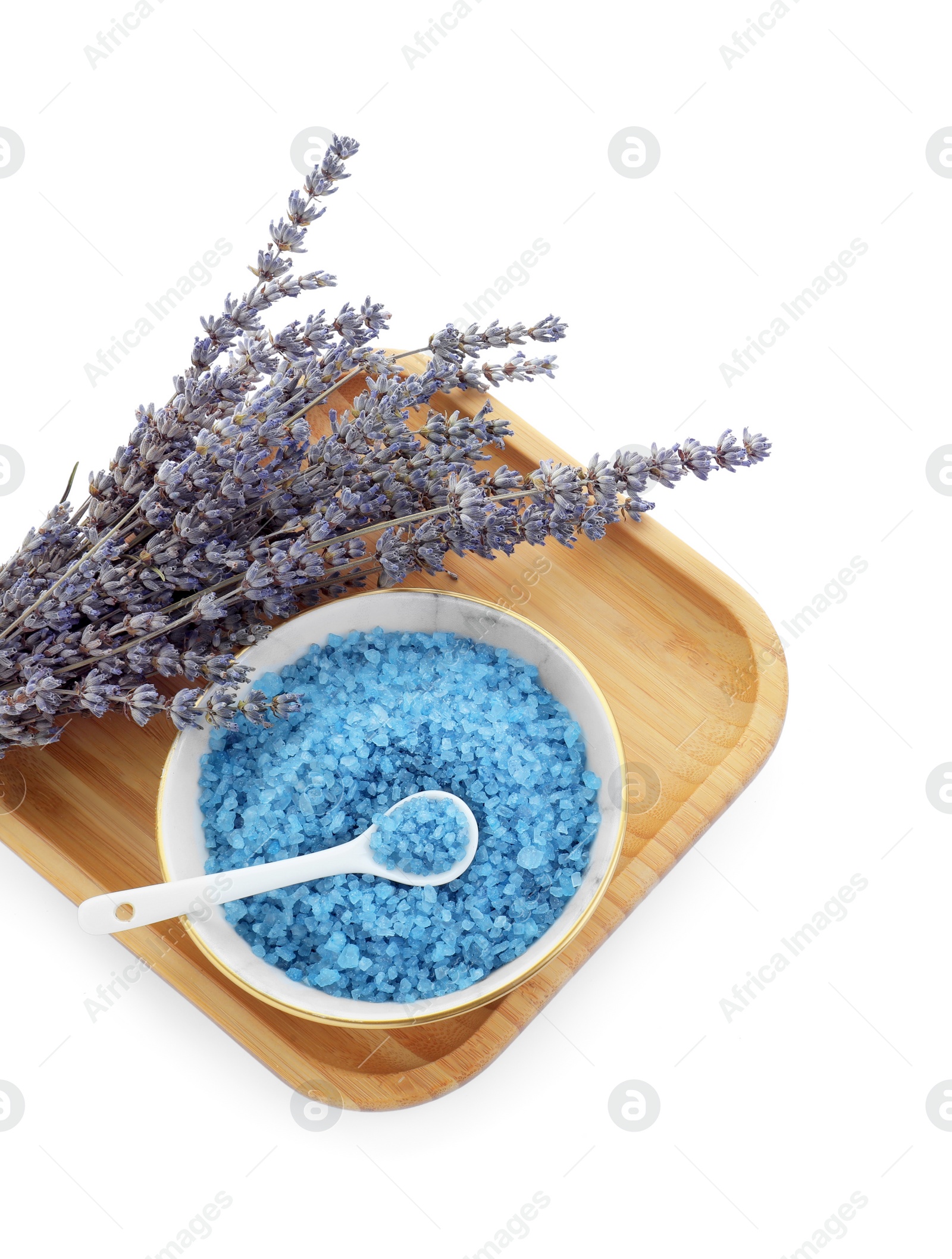 Photo of Bowl with blue sea salt and lavender flowers isolated on white, top view