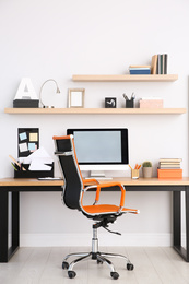 Photo of Modern computer on table in office interior. Stylish workplace