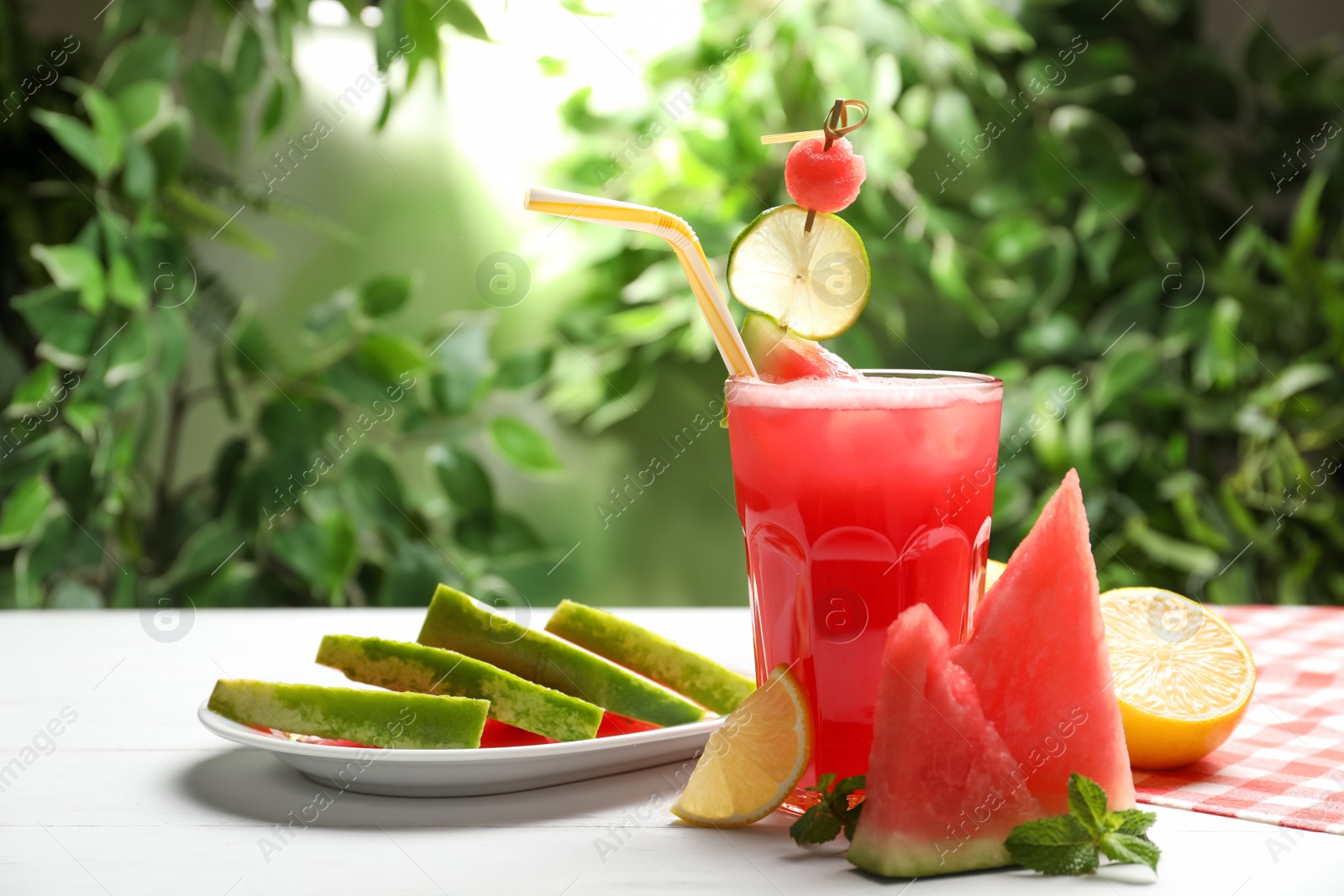 Photo of Delicious fresh watermelon drink on white wooden table