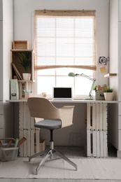 Modern home workplace with wooden crates. Eco style interior