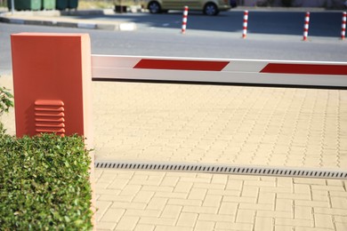 Photo of Closed boom barrier in city on sunny day