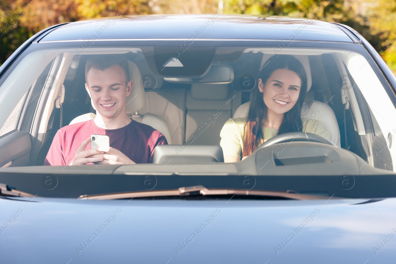 Photo of Happy young couple travelling together by car