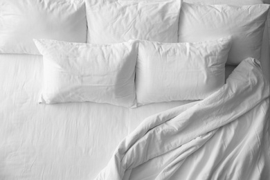 Photo of Soft pillows on comfortable bed, top view