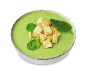 Photo of Delicious spinach cream soup with leaves and croutons in bowl isolated on white