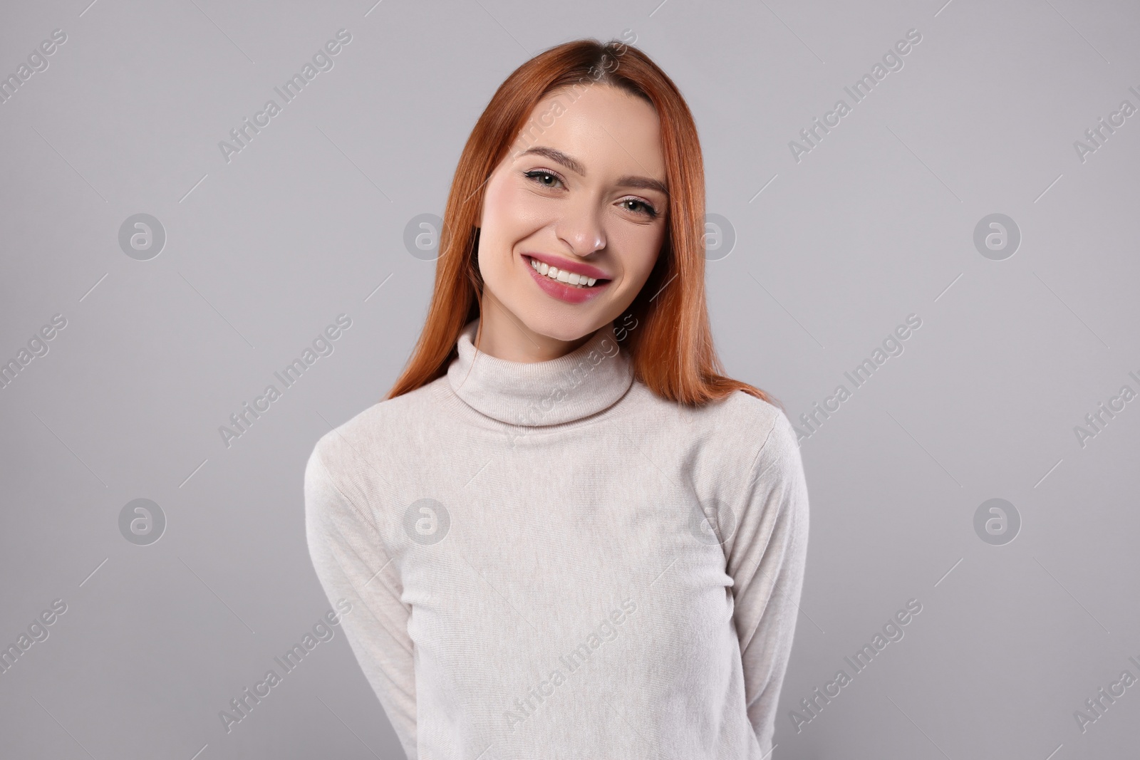 Photo of Portrait of beautiful young woman on light gray background