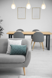 Soft pillows on grey sofa in living room