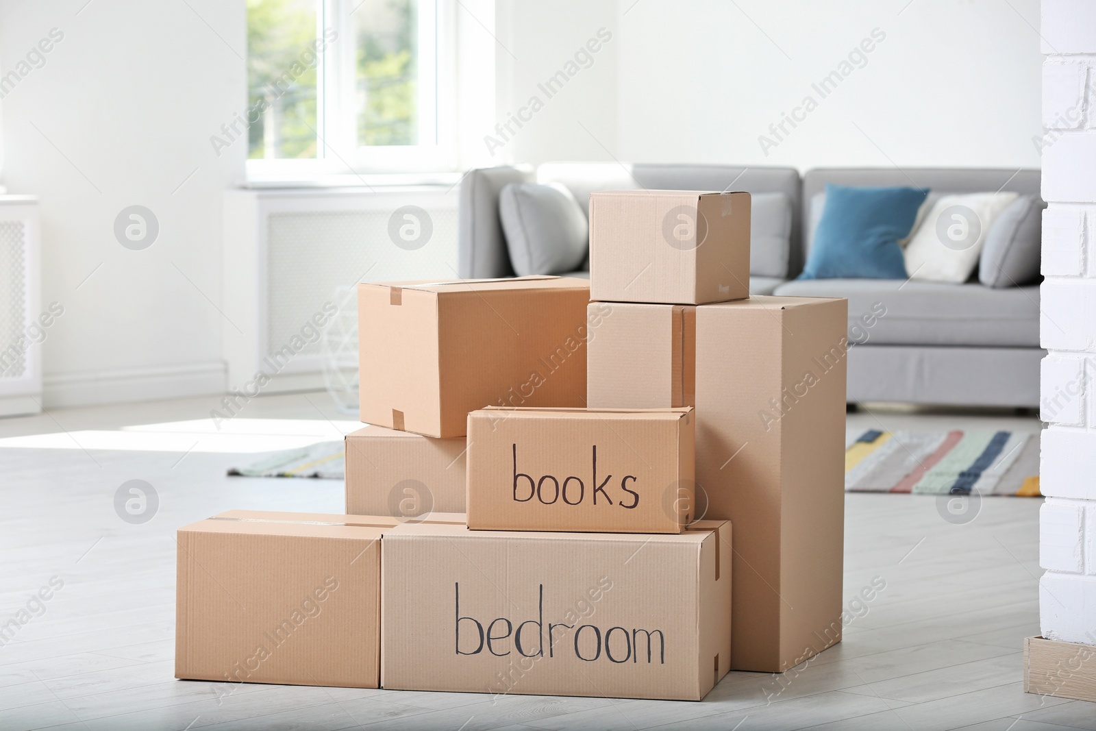 Photo of Pile of moving boxes in living room