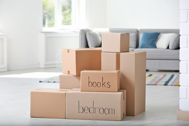 Photo of Pile of moving boxes in living room