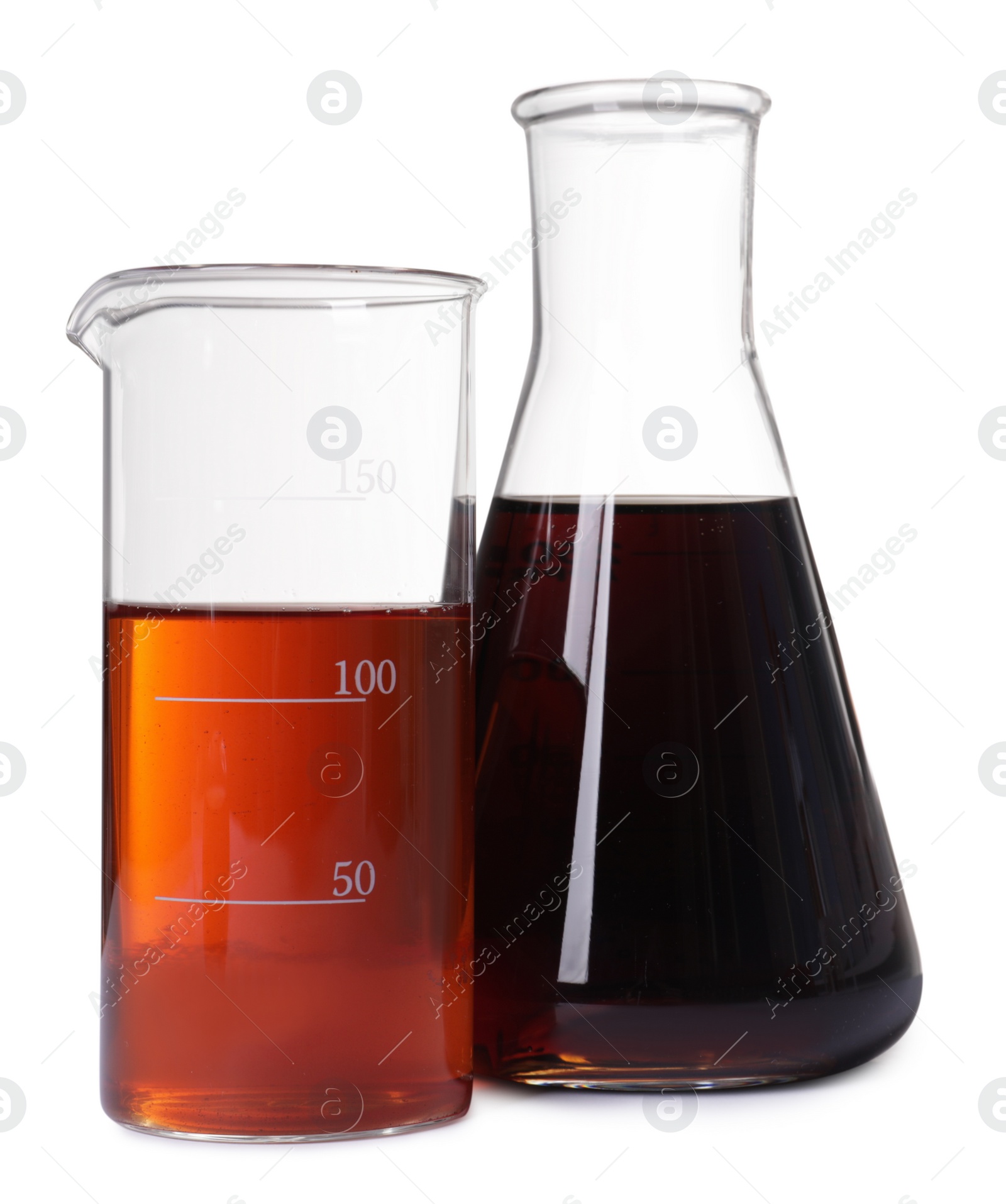 Photo of Laboratory glassware with brown liquids on white background