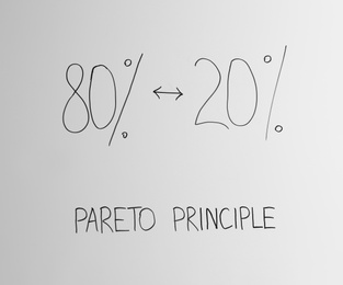 Photo of White board with 80/20 rule representation, closeup. Pareto principle concept