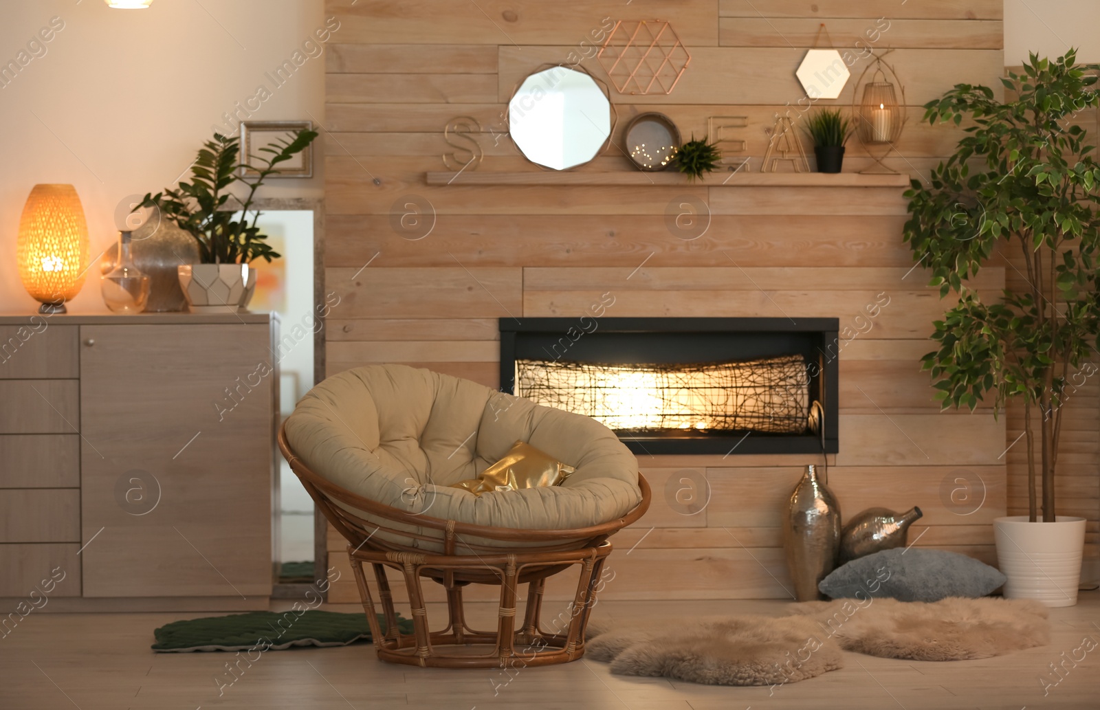 Photo of Cozy living room interior with comfortable papasan chair and decorative fireplace