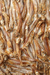 Many dried anchovies on white table, flat lay