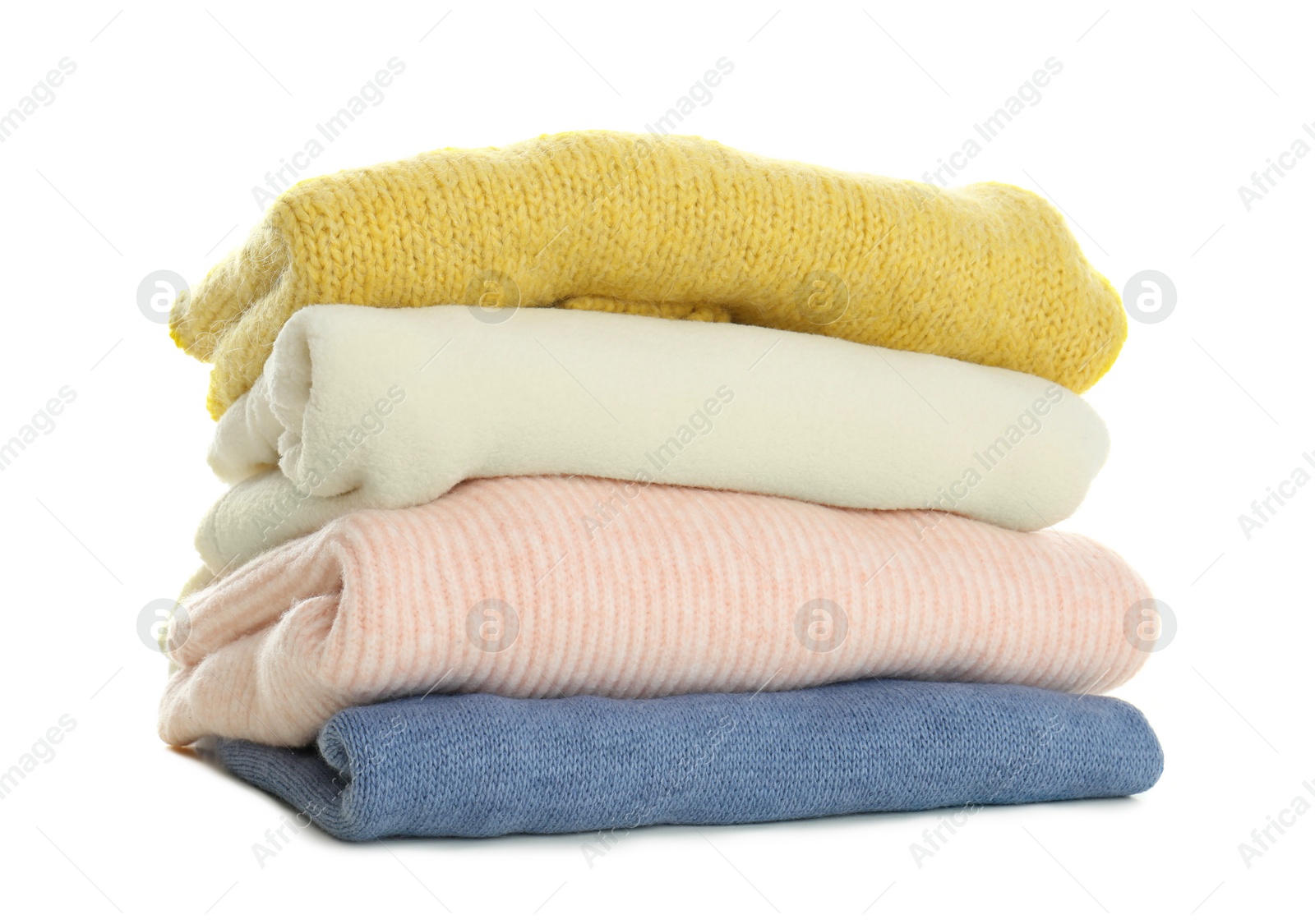 Photo of Stack of different warm sweaters isolated on white